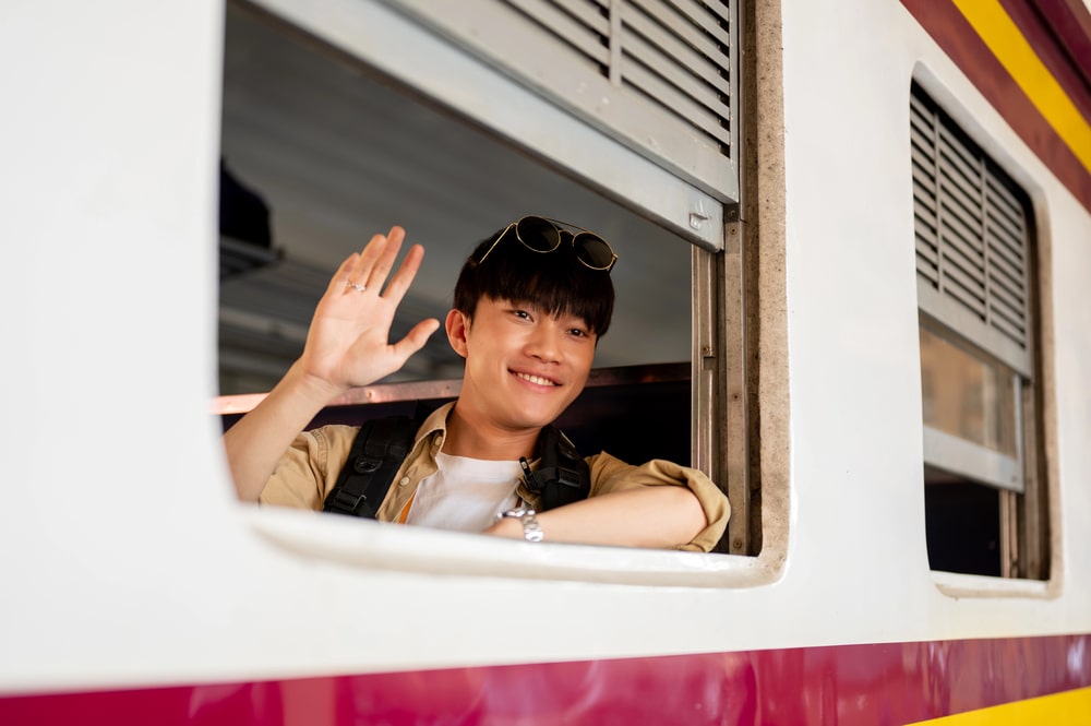 Young adult saying farewell at train station in Japan